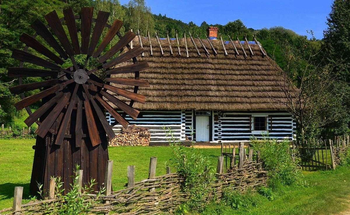 Eine Hütte mit einer Windmühle Online-Puzzle