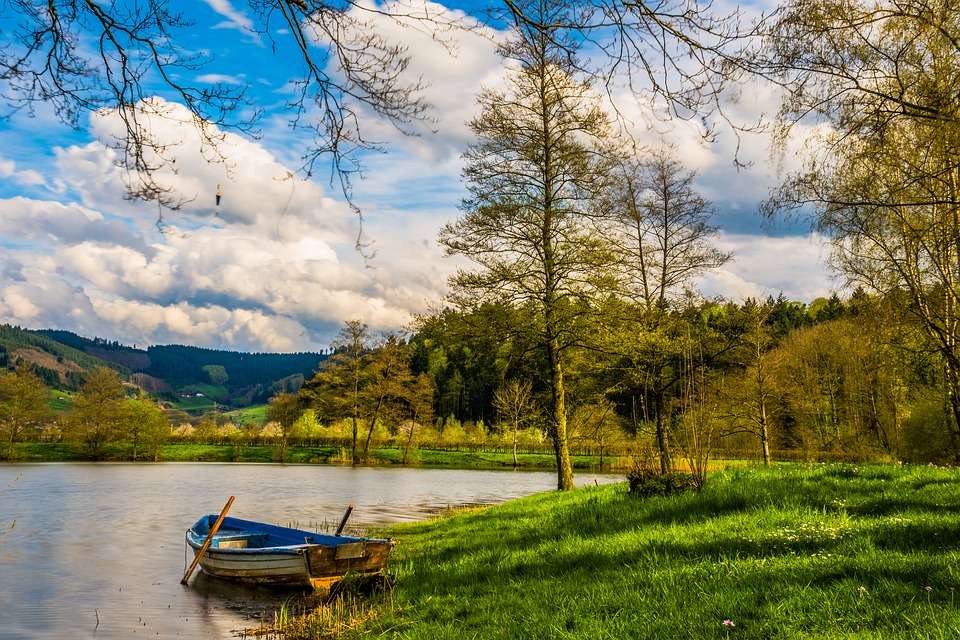 A boat on the shore of the lak jigsaw puzzle online