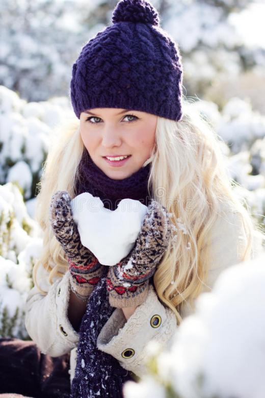 Winter girl with a heart of snow jigsaw puzzle online