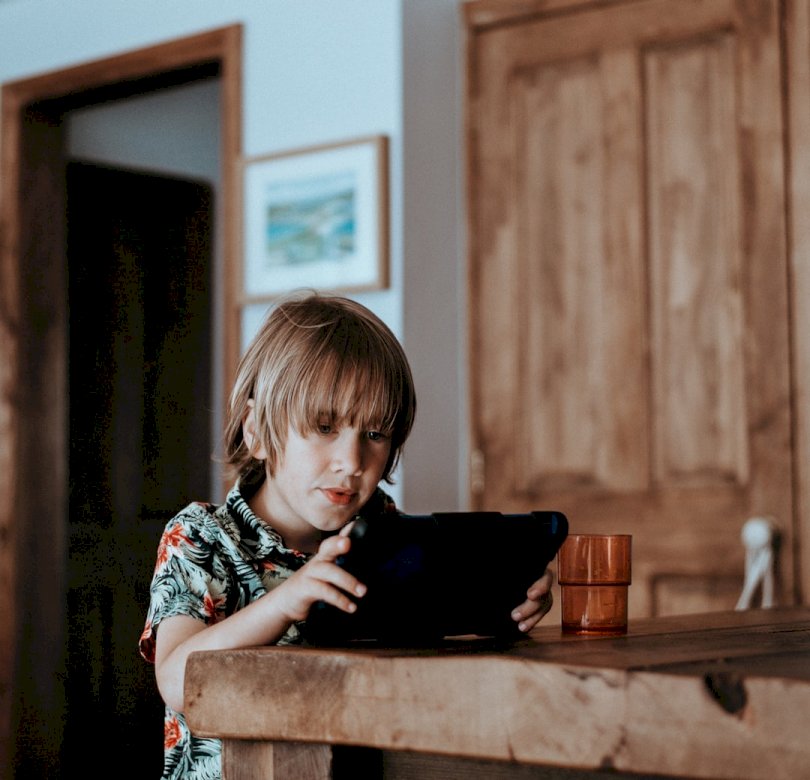 Child playing on iPad online puzzle