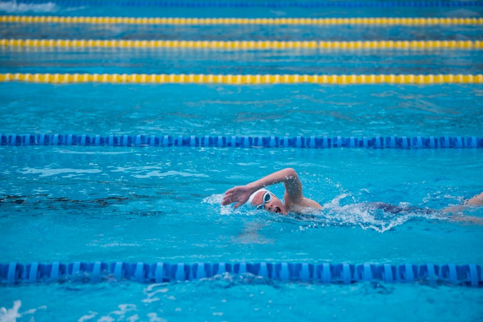 A girl swimmer swims as front jigsaw puzzle online