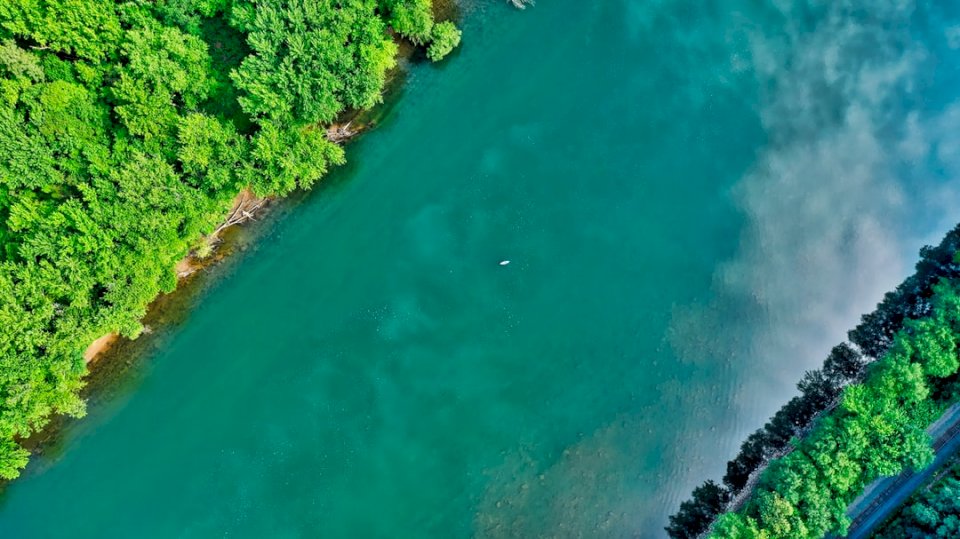 A lone kayaker on a river with online puzzle