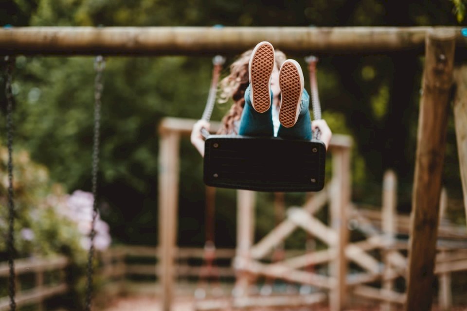 Child swinging on a swing jigsaw puzzle online