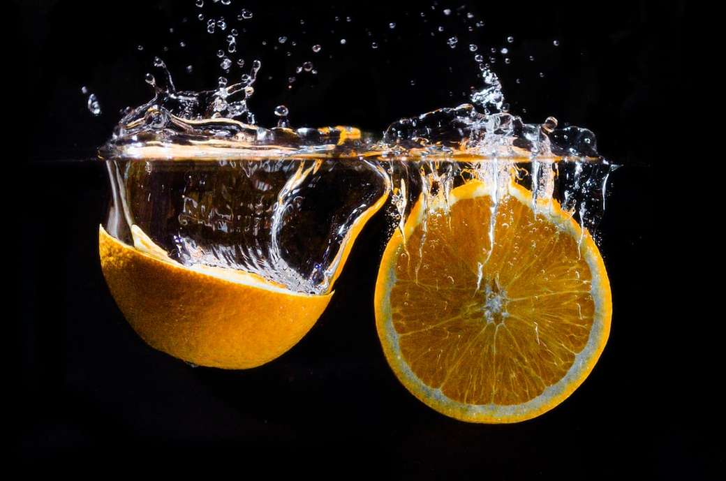 Oranges fruit dropped in water jigsaw puzzle online