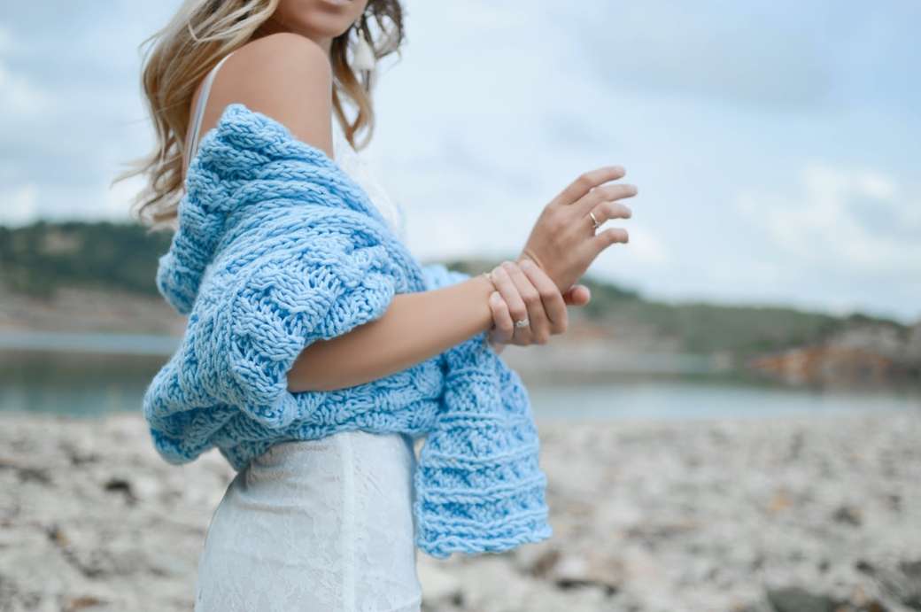 woman wearing teal crochet top and white skirt online puzzle