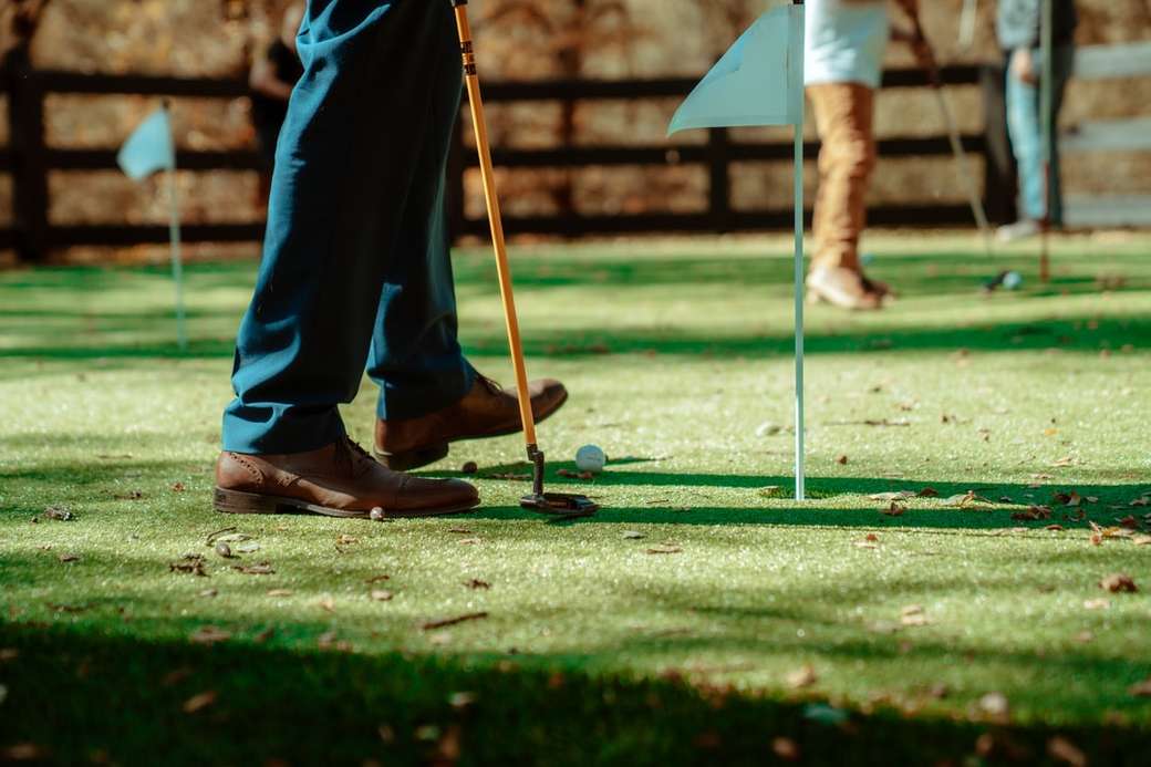pessoa de roupão azul, segurando o taco de golfe quebra-cabeças online