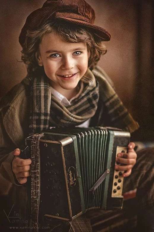 Boy playing the accordion jigsaw puzzle online