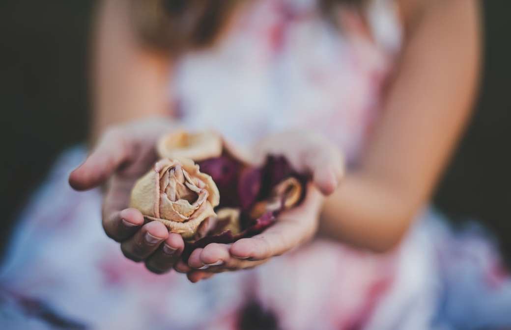 selective focus photography of a girl holding flowers online puzzle