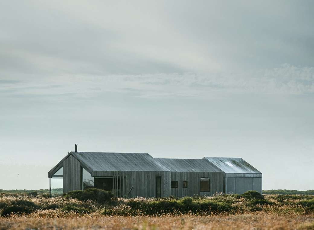 edificio in legno grigio in mezzo al campo puzzle online