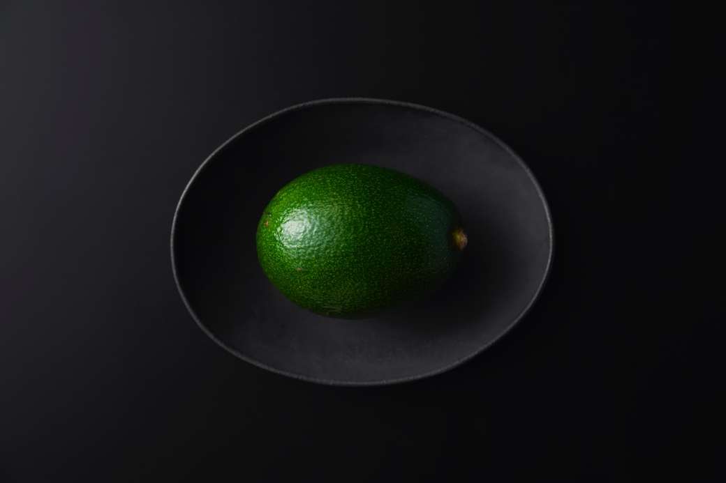 Fruta redonda verde sobre superficie negra rompecabezas en línea