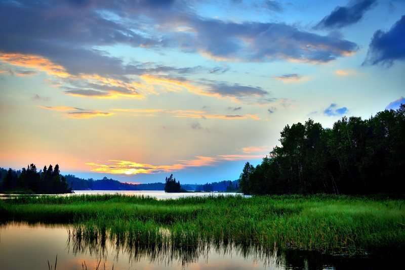 solnedgång över sjön Pussel online