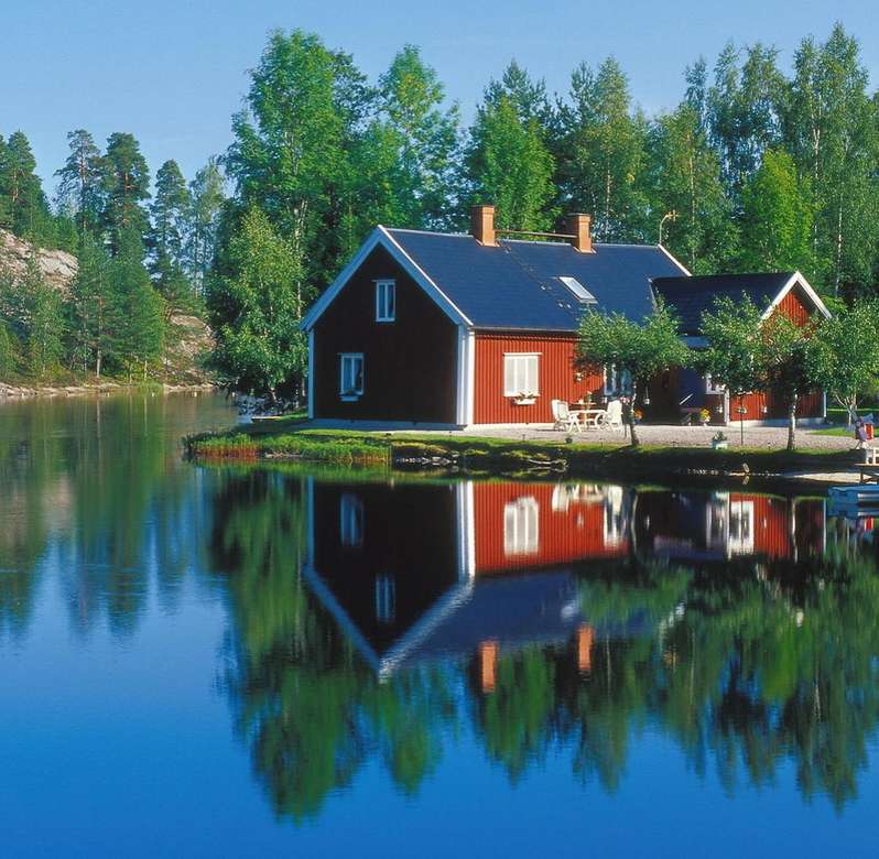 Rote Häuser am Fluss in Schweden Puzzlespiel online