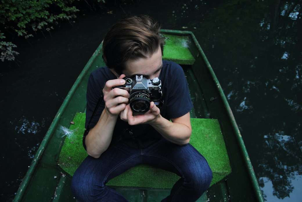 Photographer in a green boat jigsaw puzzle online