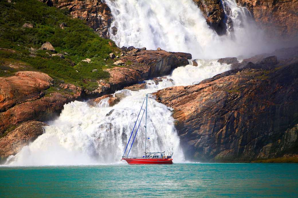 Sailboat in front of Greenland waterfall jigsaw puzzle online