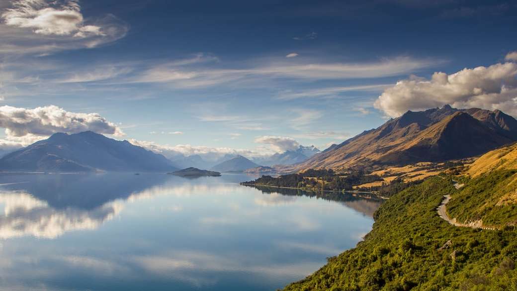 landschapsfoto van bergen dichtbij waterlichaam overdag online puzzel