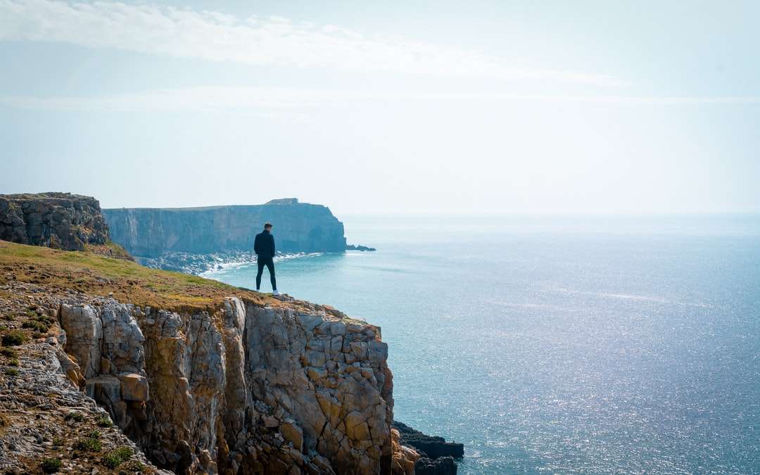 osoba stojící poblíž útesu skládačky online