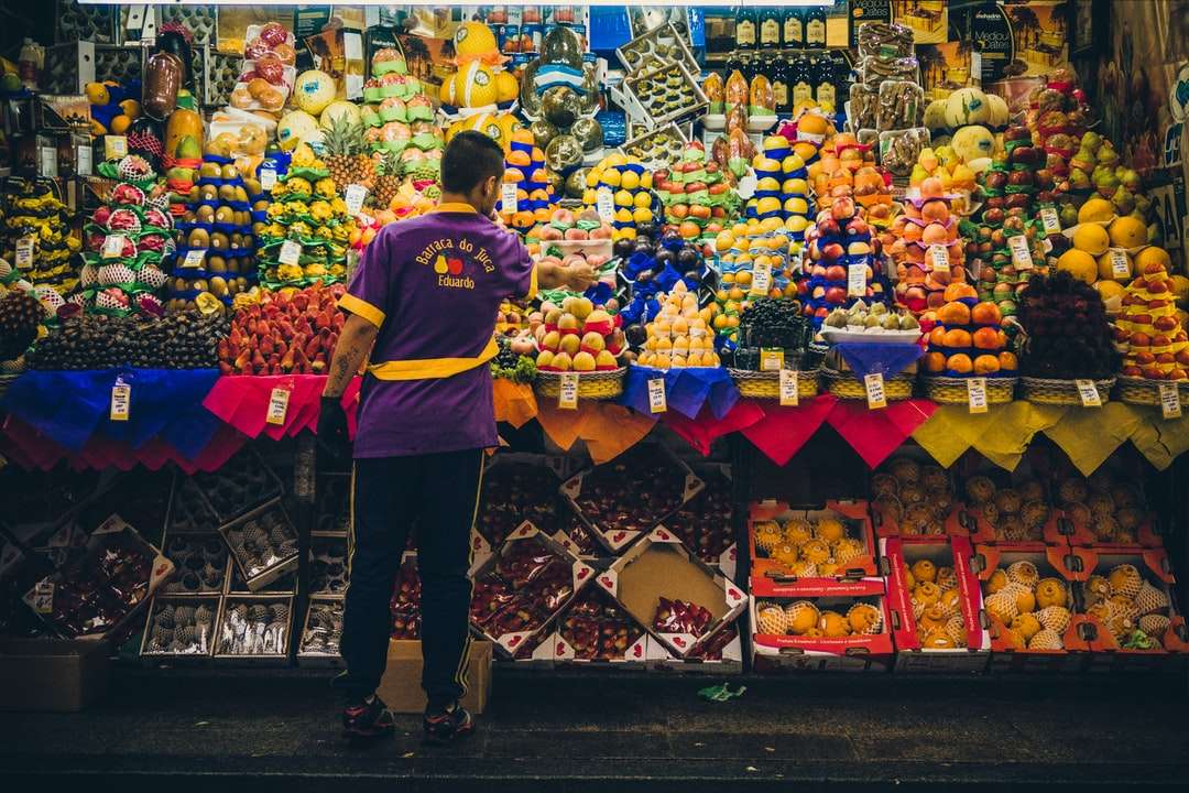 man standing in front of produce stand online puzzle