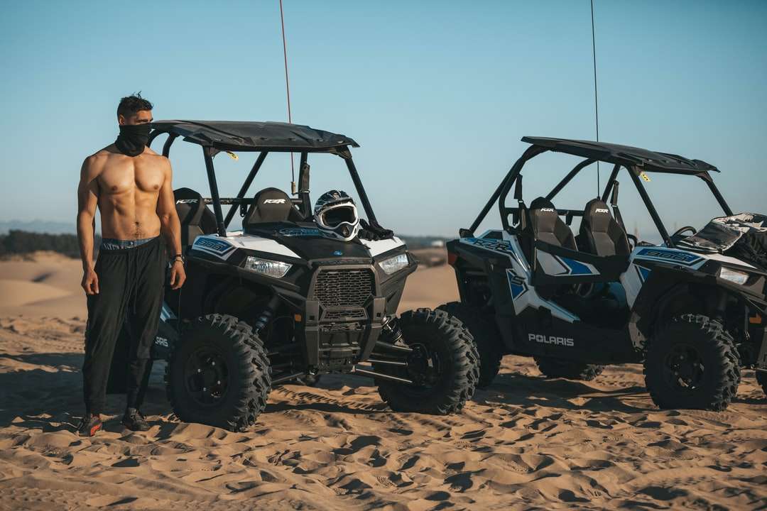 person standing beside black ATV jigsaw puzzle online