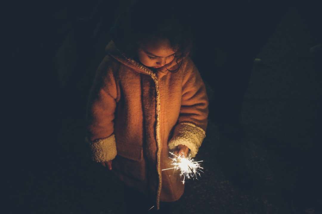 girl holding sparkler at nighttime online puzzle