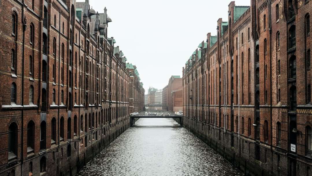 body of water between brown concrete buildings online puzzle