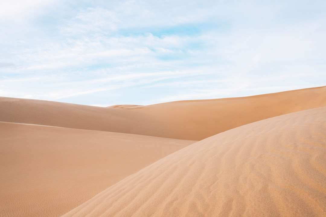 кафяв пясък под бели облаци през деня онлайн пъзел
