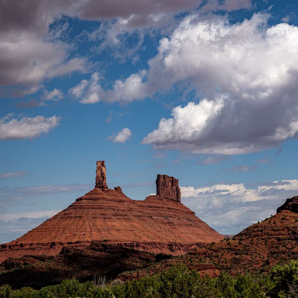 brown rock formation under white clouds and blue sky jigsaw puzzle online