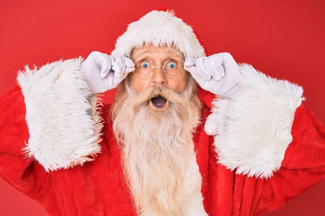 jultomten med röd bakgrund Pussel online