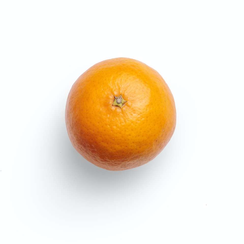 fruta naranja sobre superficie blanca rompecabezas en línea
