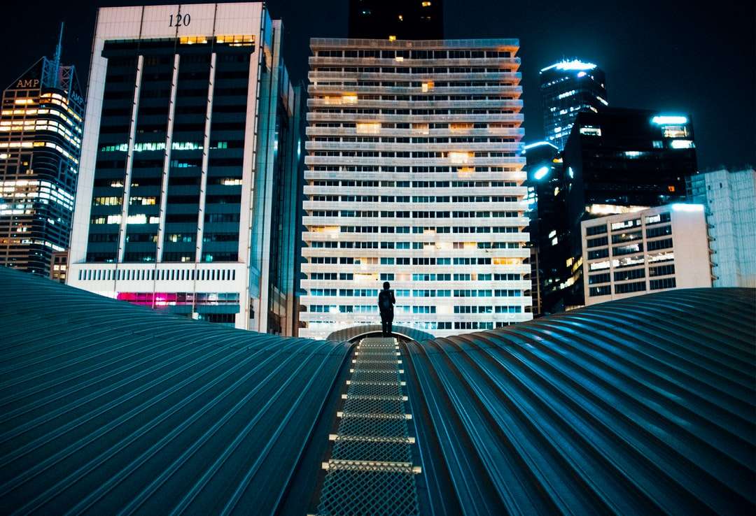 pessoa em pé no telhado do prédio com edifícios da cidade quebra-cabeças online