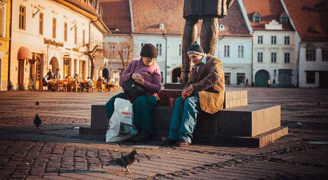 kvinna som sitter bredvid män nära statyn pussel på nätet