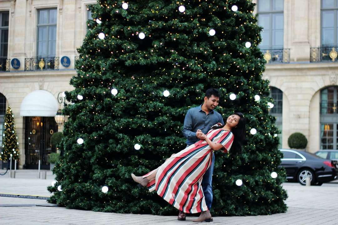 mujer y mujer cerca del árbol de navidad rompecabezas en línea