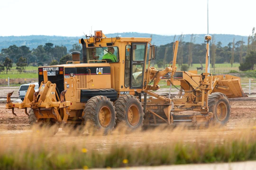 yellow and black heavy equipment on brown field online puzzle