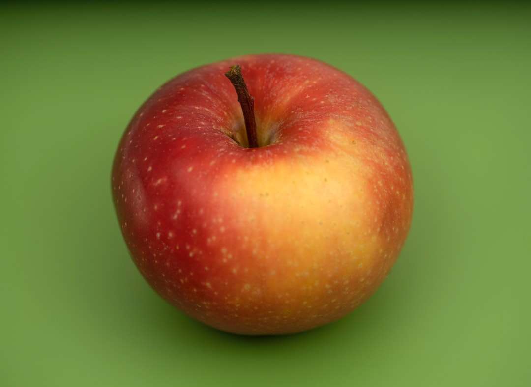 κόκκινα φρούτα μήλου στην πράσινη επιφάνεια online παζλ
