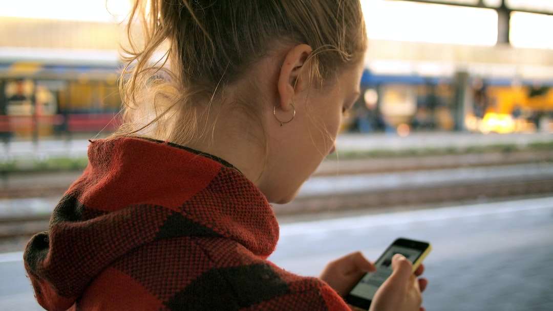 žena drží telefon skládačky online