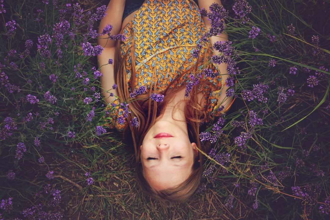 woman in yellow and teal top sleeping beside lavenders jigsaw puzzle online