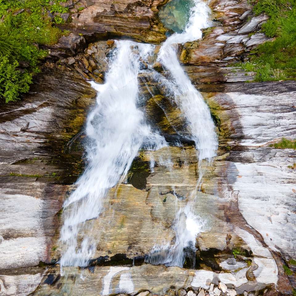 water falls on brown rocky mountain online puzzle