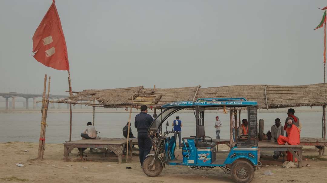 modrá a černá auto rikša na hnědé dřevěné doku skládačky online