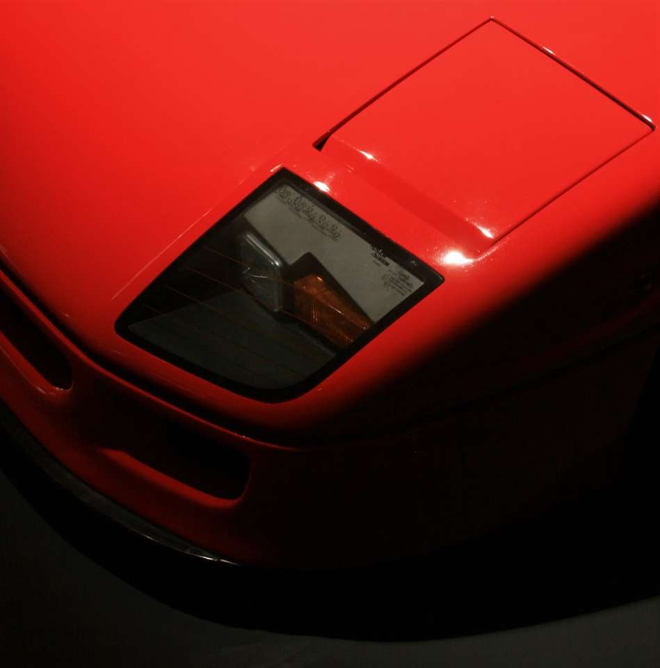 Coche Ferrari rojo en fotografía de cerca rompecabezas en línea
