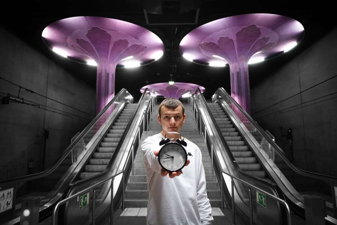 Mann im weißen Hemd, das auf Rolltreppe steht Online-Puzzle