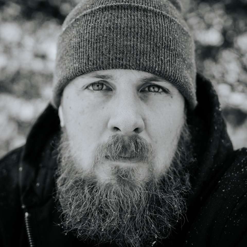 grayscale photography of man jacket and knit cap jigsaw puzzle online