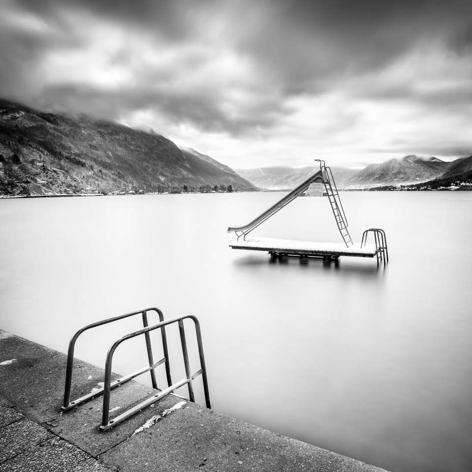 grayscale photo of boat on lake online puzzle