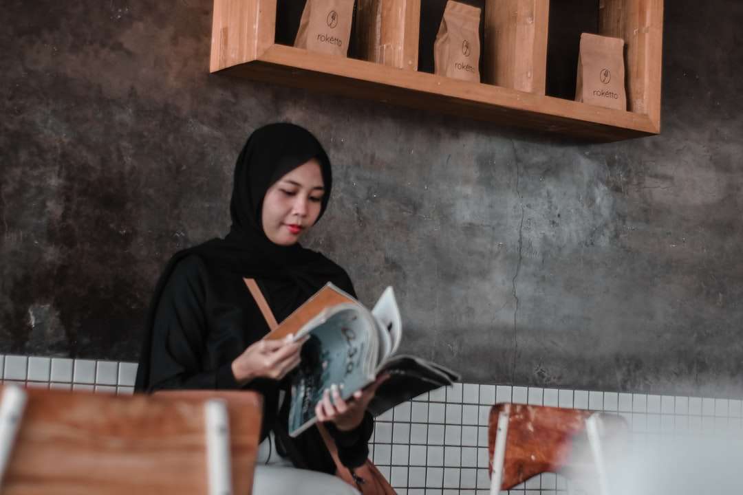 Femme en hijab noir tenant une tasse en céramique blanche puzzle en ligne