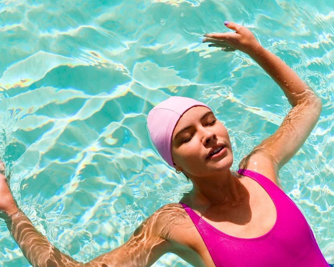 mujer en traje de baño rosa en el agua rompecabezas en línea