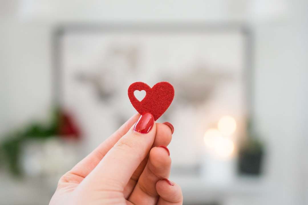 person holding pink heart ornament online puzzle