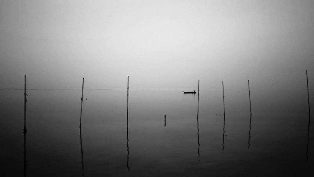 grayscale photo of 2 poles on body of water online puzzle