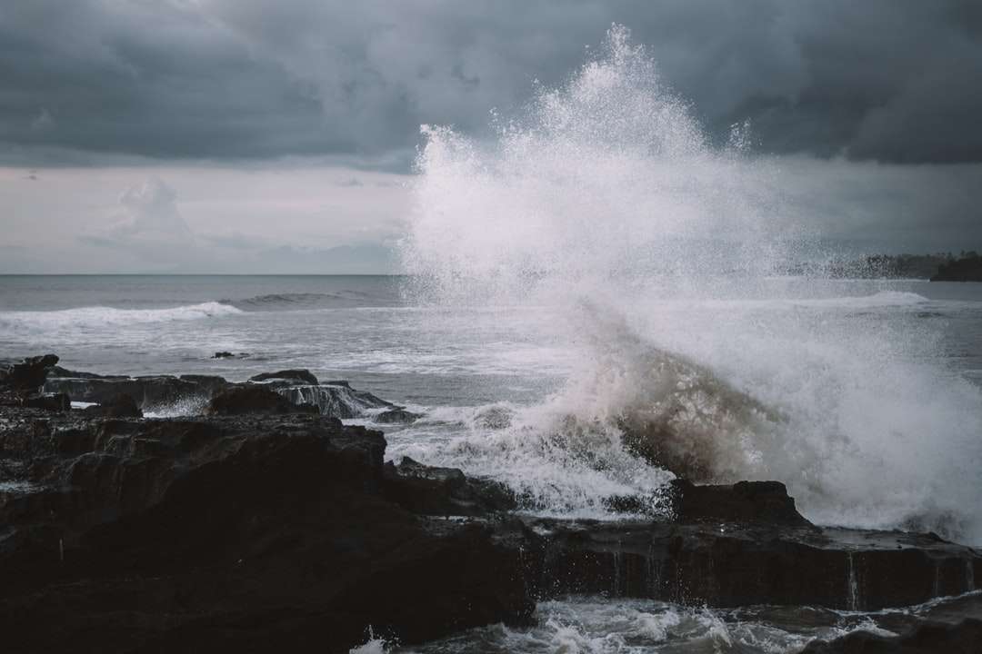 океански вълни, които се разбиват върху камъни през деня онлайн пъзел