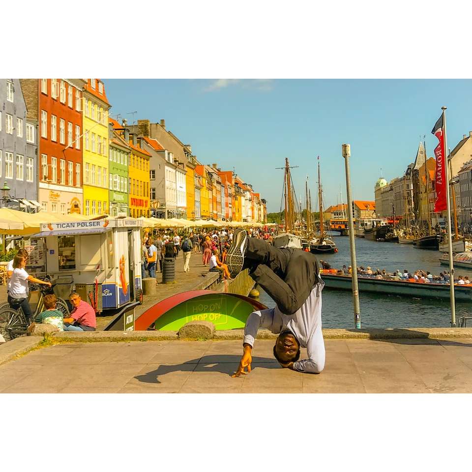 man doing head stand on bridge during daytime jigsaw puzzle online