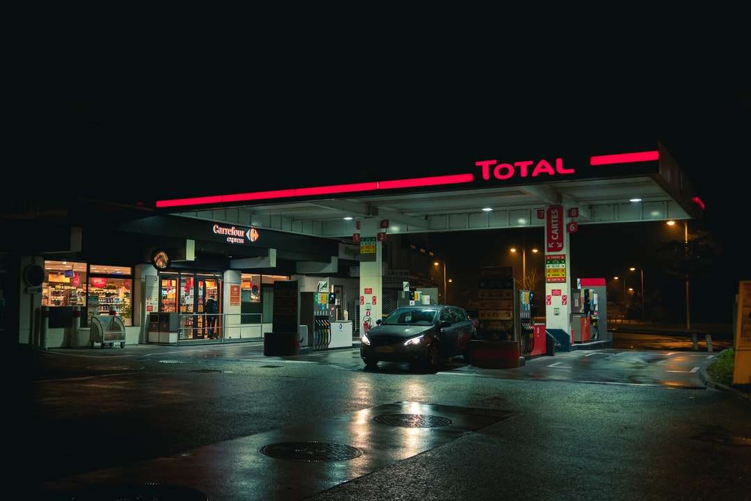 cars parked in front of store during night time online puzzle