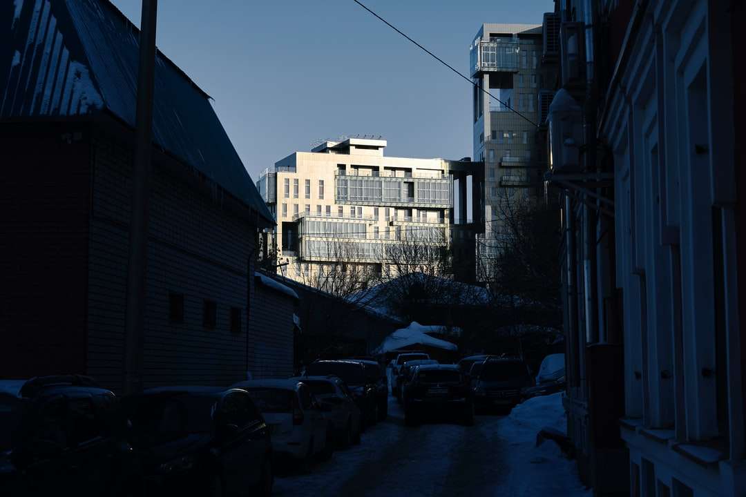 白いコンクリートの建物の横に駐車された白い車 ジグソーパズルオンライン