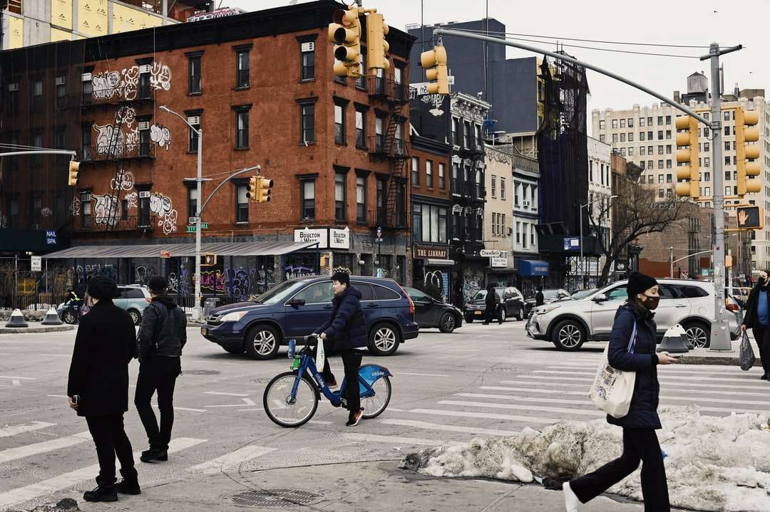bărbat în jachetă neagră și pantaloni negri mergând pe trotuar jigsaw puzzle online